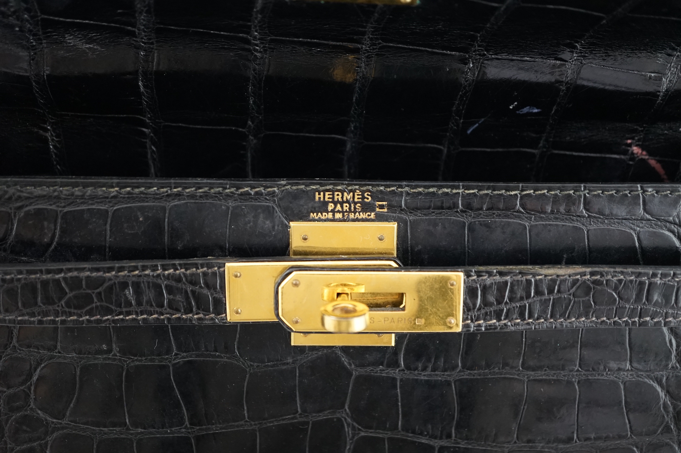 A vintage 1960's Hermès 28 Kelly in black alligator with gilt metalware, height 21cm, top of handle 31cm, width 29cm, depth 12cm